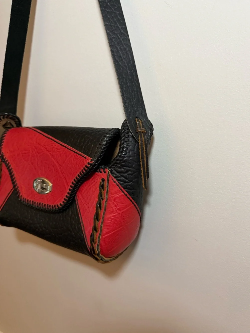 Vintage western leather black and red braided sides fringe shoulder bag purse.